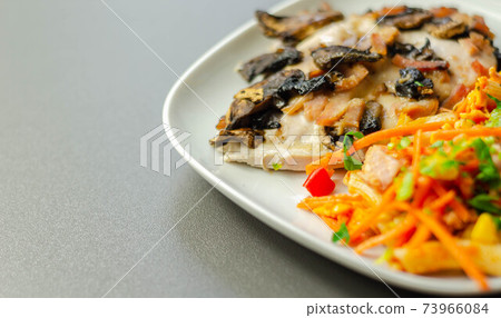 Chicken breast with sliced mushrooms, ham, in cheese sauce with pasta salad Chicken breast with sliced mushrooms, ham, in cheese sauce with pasta salad 73966084