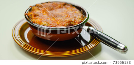 Traditional french onion gratin soup served in a ceramic bowl Traditional french onion gratin soup served in a ceramic bowl 73966188