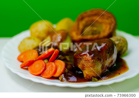 Roast potatoes and roast chicken breast in a chicken and white wine gravy with peas, carrots, pork and onion stuffing and a Yorkshire pudding Roast potatoes and roast chicken breast in a chicken and white wine gravy with peas, carrots, pork and onion stuffing and a Yorkshire pudding 73966300