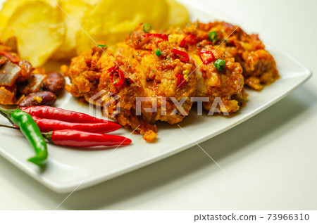 Chicken breast fillet with a chilli and cheese tomato sauce with crispy potato slices and minty bean salad Chicken breast fillet with a chilli and cheese tomato sauce with crispy potato slices and minty bean salad 73966310