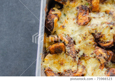 Fried potato fries coated topped with mature cheddar and Monterey Jack cheeses, jalapeno and bacon sauce, finished with mozzarella and parsley Fried potato fries coated topped with mature cheddar and Monterey Jack cheeses, jalapeno and bacon sauce, finished with mozzarella and parsley 73966523