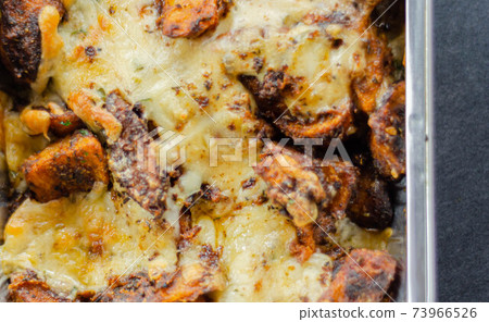 Fried potato fries coated topped with mature cheddar and Monterey Jack cheeses, jalapeno and bacon sauce, finished with mozzarella and parsley Fried potato fries coated topped with mature cheddar and Monterey Jack cheeses, jalapeno and bacon sauce, finished with mozzarella and parsley 73966526