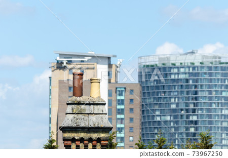 Typical English chimneys on the roofs of London buildings 73967250