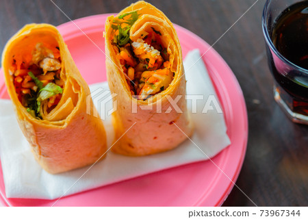 Chicken breast with piri piri sauce and lettuce in a chili tortilla wrap 73967344