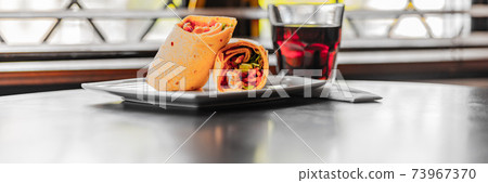 Chicken breast with piri piri sauce and lettuce in a chili tortilla wrap Chicken breast with piri piri sauce and lettuce in a chili tortilla wrap 73967370