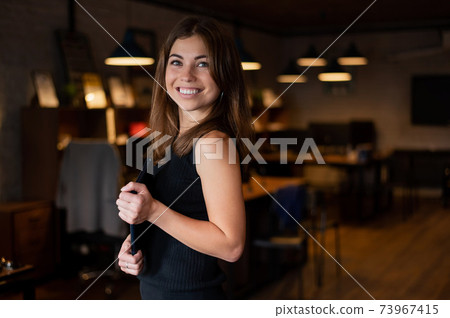 Beautiful caucasian woman in a headset is holding a digital tablet. Portrait of a business woman in the office 73967415