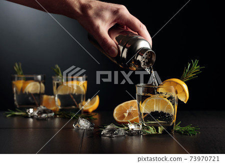 Cocktail Gin and Tonic with lemon and rosemary. 73970721