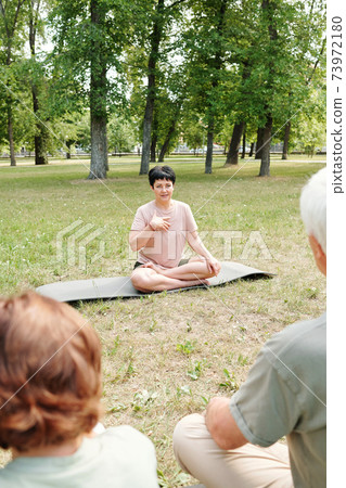 Mature woman holding classes outdoors Mature woman holding classes outdoors 73972180