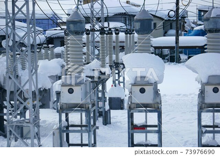 Snow-covered substation 73976690