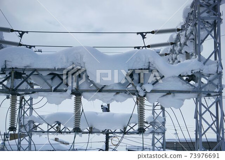 Snow-covered substation 73976691