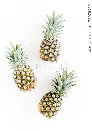 Pineapples isolated on white background. Food concept. Flat lay, top view 73976999