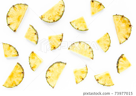 Slices pineapple with green leaves isolated on white background. Flat lay, top view Slices pineapple with green leaves isolated on white background. Flat lay, top view 73977015