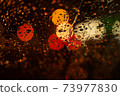 View of the night city through the wet car window with drops 73977830