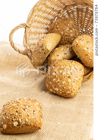 Loaf bread. Rye bakery with crusty loaves and crumbs. Fresh loaf of rustic traditional bread with wheat grain ear or spike plant on natural cotton background. Bio ingredients, very healthy seeds. 73978764