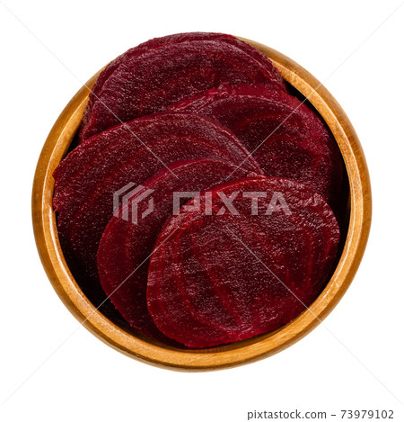 Cooked beetroot slices in a wooden bowl. Boiled sliced red beets also known as table, garden, dinner or golden beets. Beta vulgaris. Taproots. Food and food coloring. Close-up, from above, food photo. Cooked beetroot slices in a wooden bowl. Boiled sliced red beets also known as table, garden, dinner or golden beets. Beta vulgaris. Taproots. Food and food coloring. Close-up, from above, food photo. 73979102