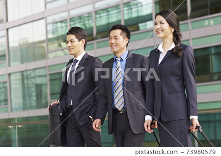 team of asian business people with modern building background 73980579