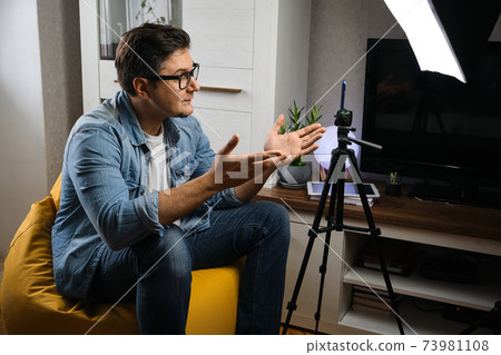 Young male blogger recording video at home 73981108