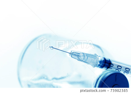 Vaccine dripping from sterile needle syringe macro close u, Health concepts. 73982385