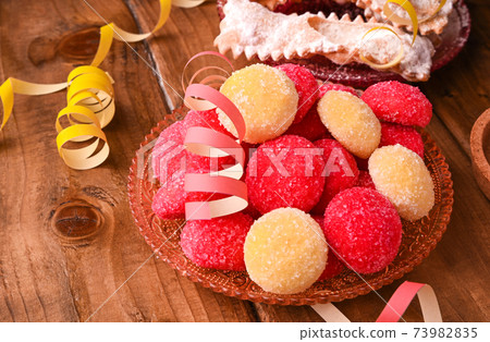 Baked castagnole. Traditional sweet pastries during the carnival period in italy. Street food, round 73982835