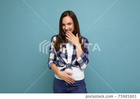 Young positive happy beautiful winsom brunette woman with sincere emotions wearing check shirt 73985801