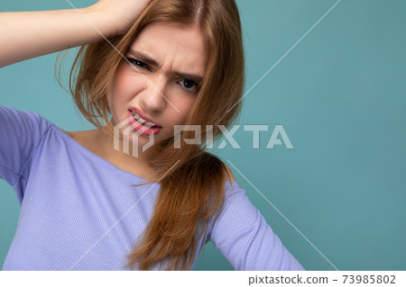 Dissatisfied angry young beautiful dark blonde woman with sincere emotions isolated on background 73985802