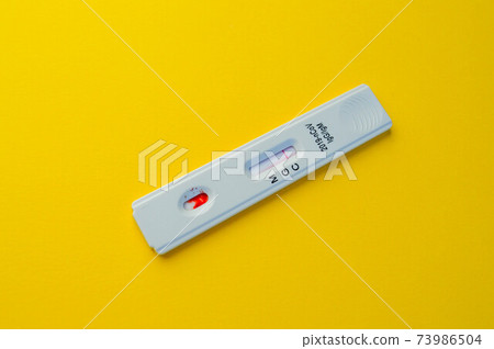 test for coronavirus lies on a yellow background. a drop of blood on a test strip. rapid diagnosis of coronavirus, detection of IgG and IgM antibodies. coronavirus testing test for coronavirus lies on a yellow background. a drop of blood on a test strip. rapid diagnosis of coronavirus, detection of IgG and IgM antibodies. coronavirus testing 73986504