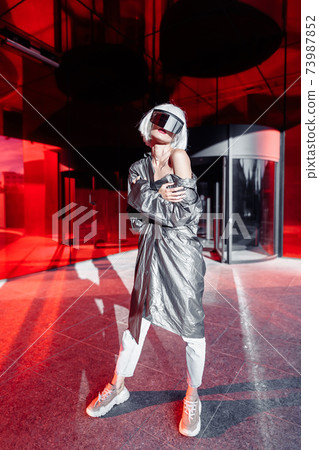 Stylish young woman in futuristic clothes. Stylish young woman in futuristic clothes. 73987852