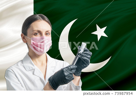 Girl doctor prepares vaccination against the background of the Pakistan flag. Vaccination concept Pakistan 73987954