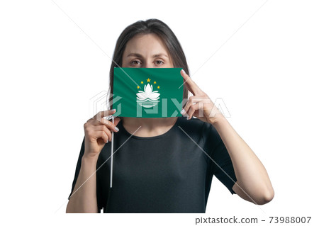 Happy young white woman holding flag Macau flag and covers her face with it isolated on a white background 73988007