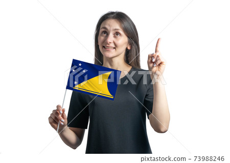 Happy young white woman holding flag of Tokelau and points thumbs up isolated on a white background Happy young white woman holding flag of Tokelau and points thumbs up isolated on a white background 73988246