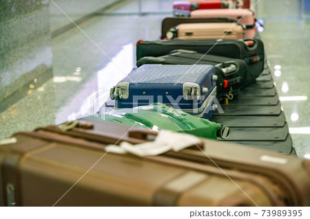 Suitcase and luggage in line in the international airport Suitcase and luggage in line in the international airport 73989395