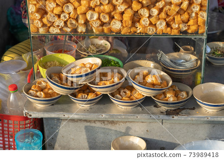 Cut deep-fried bread sticks - youtiao at breakfast stall on the street 73989418