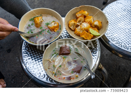 Chao Long - Vietnamese bloodcake porridge served with fried bread sticks 73989423
