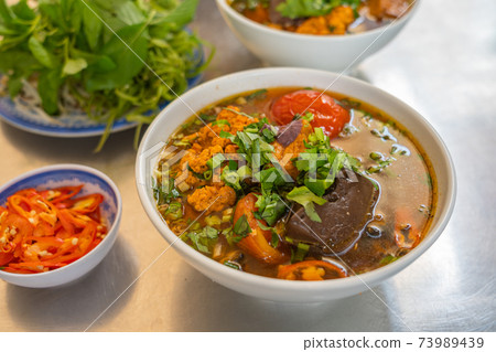 Vietnamese cuisine - tasty crab and tomato noodle, Bun Rieu 73989439