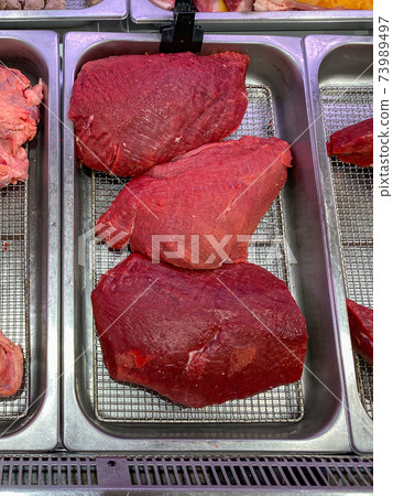 Vertical photo of fresh beef meat for sale at butcher shop Vertical photo of fresh beef meat for sale at butcher shop 73989497
