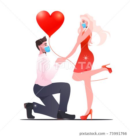 man woman in masks celebrating valentines day coronavirus quarantine concept man woman in masks celebrating valentines day coronavirus quarantine concept 73991766