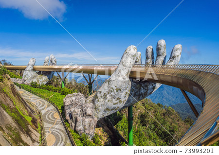 Famous tourist attraction - Golden bridge at the top of the Ba Na Hills, Vietnam Famous tourist attraction - Golden bridge at the top of the Ba Na Hills, Vietnam 73993201