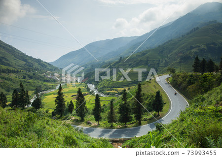 Curve of road across mountain on hill 73993455