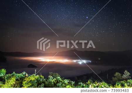 foggy above mountain againts sky 73993483