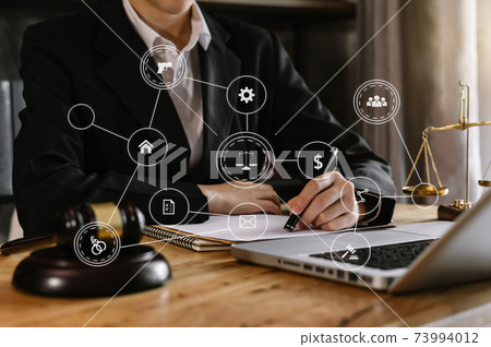 justice and law concept.Male judge in a courtroom the gavel, working with smart phone and laptop and digital tablet computer on wood table in morning light . justice and law concept.Male judge in a courtroom the gavel, working with smart phone and laptop and digital tablet computer on wood table in morning light . 73994012