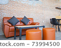 Leather orange sofa with brick wall brown background 73994500