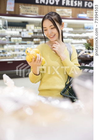 Female shoppers shopping at the supermarket 73994503
