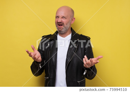 Displeased man with beard gesturing actively, frowning face while arguing 73994510