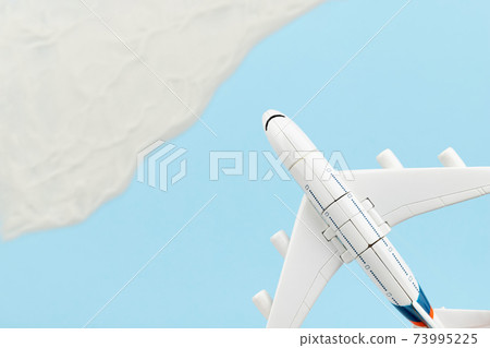 Creative composition with toy airplane and sand 73995225