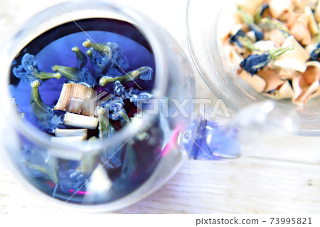 Butterfly peach tea, blue herbal tea in a glass teapot Butterfly peach tea, blue herbal tea in a glass teapot 73995821