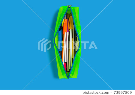 yellow pencil case on a blue surface yellow pencil case on a blue surface 73997809