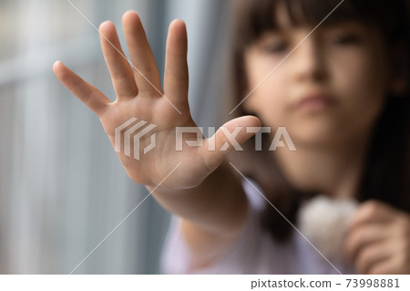 Close up lonely little girl offering hand, asking help Close up lonely little girl offering hand, asking help 73998881