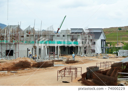 SEREMBAN, MALAYSIA -APRIL 09, 2020: New double story luxury terrace house under construction in Malaysia.  Designed by an architect with a modern and contemporary style.  74000229