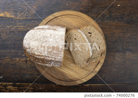 Sliced bread on a cutting board. 74000276