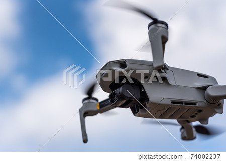 Unmanned drone flying in the sky Unmanned drone flying in the sky 74002237
